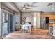 Cozy dining area featuring hardwood floors, a stylish ceiling fan, and easy access to both kitchen and patio at 14246 W Columbus Ave, Goodyear, AZ 85395