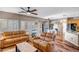 Open-concept living room boasts hardwood floors, plenty of seating, and seamless transition to the dining area at 14246 W Columbus Ave, Goodyear, AZ 85395