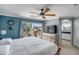 Serene main bedroom with a ceiling fan, en-suite bathroom, and private balcony access offering scenic outdoor views at 14246 W Columbus Ave, Goodyear, AZ 85395