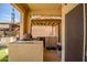 Covered outdoor kitchen with a built-in brick oven and ample counter space at 14246 W Columbus Ave, Goodyear, AZ 85395