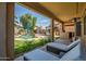 Relaxing covered patio with lounge chairs overlooking the pool and landscaped backyard at 14246 W Columbus Ave, Goodyear, AZ 85395