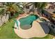 Aerial view of a private pool with waterfall feature, spa, and lush landscaping at 14246 W Columbus Ave, Goodyear, AZ 85395