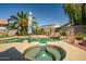 Inviting in-ground spa with clear water and adjacent pool with waterfall feature at 14246 W Columbus Ave, Goodyear, AZ 85395