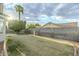Wide shot of the new lawn and block fence in this spacious backyard with a mature palm tree and cloudscape sky at 1584 E Harrison E St, Chandler, AZ 85225