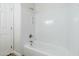 Clean bathroom features a white shower-tub combo with modern fixtures and a minimalist design at 1584 E Harrison E St, Chandler, AZ 85225