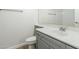 Bathroom featuring a gray vanity with white sink, toilet and gold framed mirror above at 1584 E Harrison E St, Chandler, AZ 85225