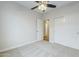 Neutral bedroom features plush carpeting, ceiling fan, closet with white sliding doors, and abundant natural light at 1584 E Harrison E St, Chandler, AZ 85225