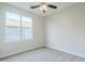 Well-lit bedroom features neutral walls, plush carpeting, and large window providing ample natural light at 1584 E Harrison E St, Chandler, AZ 85225