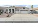 Charming single-story home featuring a three-car garage, tiled roof, and desert landscaping at 1584 E Harrison E St, Chandler, AZ 85225
