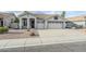 Charming single-story home featuring a three-car garage, tiled roof, and desert landscaping at 1584 E Harrison E St, Chandler, AZ 85225