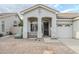 Inviting front entrance with an arched entryway, security door, and desert landscaping at 1584 E Harrison E St, Chandler, AZ 85225
