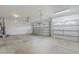 Two-car garage featuring paneled doors, clean concrete floors, overhead lighting, and water heater at 1584 E Harrison E St, Chandler, AZ 85225