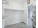 Bright walk-in closet features adjustable shelving and a neutral color palette, ready for personalized organization at 1584 E Harrison E St, Chandler, AZ 85225