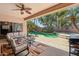 Covered patio offering comfortable seating and views of the backyard pool area with lush landscaping at 16753 W Bristol Ln, Surprise, AZ 85374