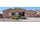 Inviting single-story home featuring a well-manicured front yard with desert landscaping at 16753 W Bristol Ln, Surprise, AZ 85374