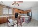 Eat-in kitchen area showcases wood cabinets, an island with seating, and views of the decorative backsplash at 16753 W Bristol Ln, Surprise, AZ 85374