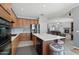 Bright kitchen features wood cabinetry, stainless steel appliances, a spacious island, and seamless access to living area at 16753 W Bristol Ln, Surprise, AZ 85374