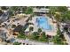Aerial view of the community pool, playground, and amenities with lush landscaping at 16923 W Canterbury Dr, Surprise, AZ 85388