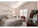 Bright bedroom with shutters, a ceiling fan, and cozy furnishings at 17119 N Joshua Path, Surprise, AZ 85374