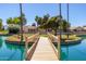 Scenic view of a tranquil pond with a wooden bridge in a peaceful community at 17119 N Joshua Path, Surprise, AZ 85374