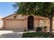 Charming single-story home featuring an arched entryway, desert landscaping, and a two-car garage at 17119 N Joshua Path, Surprise, AZ 85374