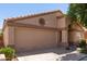 Single-story home featuring a desert landscape, a round window accent and a two-car garage at 17119 N Joshua Path, Surprise, AZ 85374