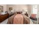 Comfortable main bedroom with a large bed, two side tables, and lots of pillows at 17119 N Joshua Path, Surprise, AZ 85374