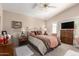 Vaulted main bedroom featuring a large bed, a ceiling fan and a view of the backyard at 17119 N Joshua Path, Surprise, AZ 85374