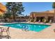 Resort-style pool features chaise lounges, shady umbrellas, and blue tiled water for relaxing swims at 17119 N Joshua Path, Surprise, AZ 85374