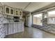 Bright eat-in kitchen featuring ample cabinet space, stainless appliances, and rustic gray washed brick walls at 17200 W Bell Rd # 324, Surprise, AZ 85374