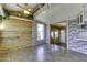 Inviting living room featuring wood paneled walls and brick accents, filled with natural light from large windows at 17200 W Bell Rd # 324, Surprise, AZ 85374