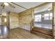 Open-concept living room showcasing hardwood floors, wood paneling, and staircase at 17200 W Bell Rd # 324, Surprise, AZ 85374