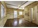 Bright living room boasts wood paneling, wood floors, and access to bathroom at 17200 W Bell Rd # 324, Surprise, AZ 85374