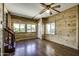Bright living room with wood paneling, hardwood floors, ceiling fan, and natural light at 17200 W Bell Rd # 324, Surprise, AZ 85374