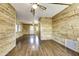 Spacious living room with hardwood floors and wood paneling, offering ample natural light at 17200 W Bell Rd # 324, Surprise, AZ 85374