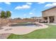 Resort-style backyard featuring a large pool, water feature, and lush landscaping for outdoor enjoyment at 1754 E Bradstock Way, San Tan Valley, AZ 85140