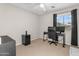 Comfortable bedroom setup as home office with neutral walls and carpeting at 1754 E Bradstock Way, San Tan Valley, AZ 85140