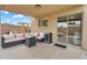 Relaxing covered patio space, furnished for outdoor lounging and enjoying the backyard view at 1754 E Bradstock Way, San Tan Valley, AZ 85140