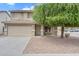 Inviting two-story home featuring a classic facade, two-car garage, and drought-tolerant landscaping at 1754 E Bradstock Way, San Tan Valley, AZ 85140