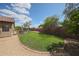 Expansive backyard featuring lush green grass, mature trees, and a privacy fence at 17806 N 54Th Ln, Glendale, AZ 85308