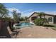 Spacious backyard with lush grass, gravel landscaping, mature trees, and a refreshing pool at 17806 N 54Th Ln, Glendale, AZ 85308