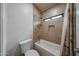 This bathroom features tiled shower and shower-tub combo with a small window at 17806 N 54Th Ln, Glendale, AZ 85308