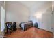 This bedroom features wood floors, light walls, and a door for easy access at 17806 N 54Th Ln, Glendale, AZ 85308