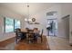 Dining room featuring hardwood floors, a chandelier, and lots of sunlight at 17806 N 54Th Ln, Glendale, AZ 85308