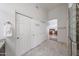 Hallway with closet leading into bedroom with light tile flooring at 17806 N 54Th Ln, Glendale, AZ 85308