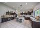 Open concept kitchen with large center island, tile floors, and bar seating at 17806 N 54Th Ln, Glendale, AZ 85308