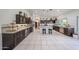 Large kitchen with spacious cabinets, tile floors, and stainless refrigerator at 17806 N 54Th Ln, Glendale, AZ 85308
