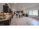 Spacious kitchen with dark cabinetry, granite countertops, island with barstool seating at 17806 N 54Th Ln, Glendale, AZ 85308