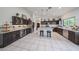 Kitchen featuring spacious cabinets, tiled floors, and stainless refrigerator at 17806 N 54Th Ln, Glendale, AZ 85308