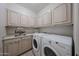 Convenient laundry room with modern washer, dryer, and ample cabinet space at 17806 N 54Th Ln, Glendale, AZ 85308